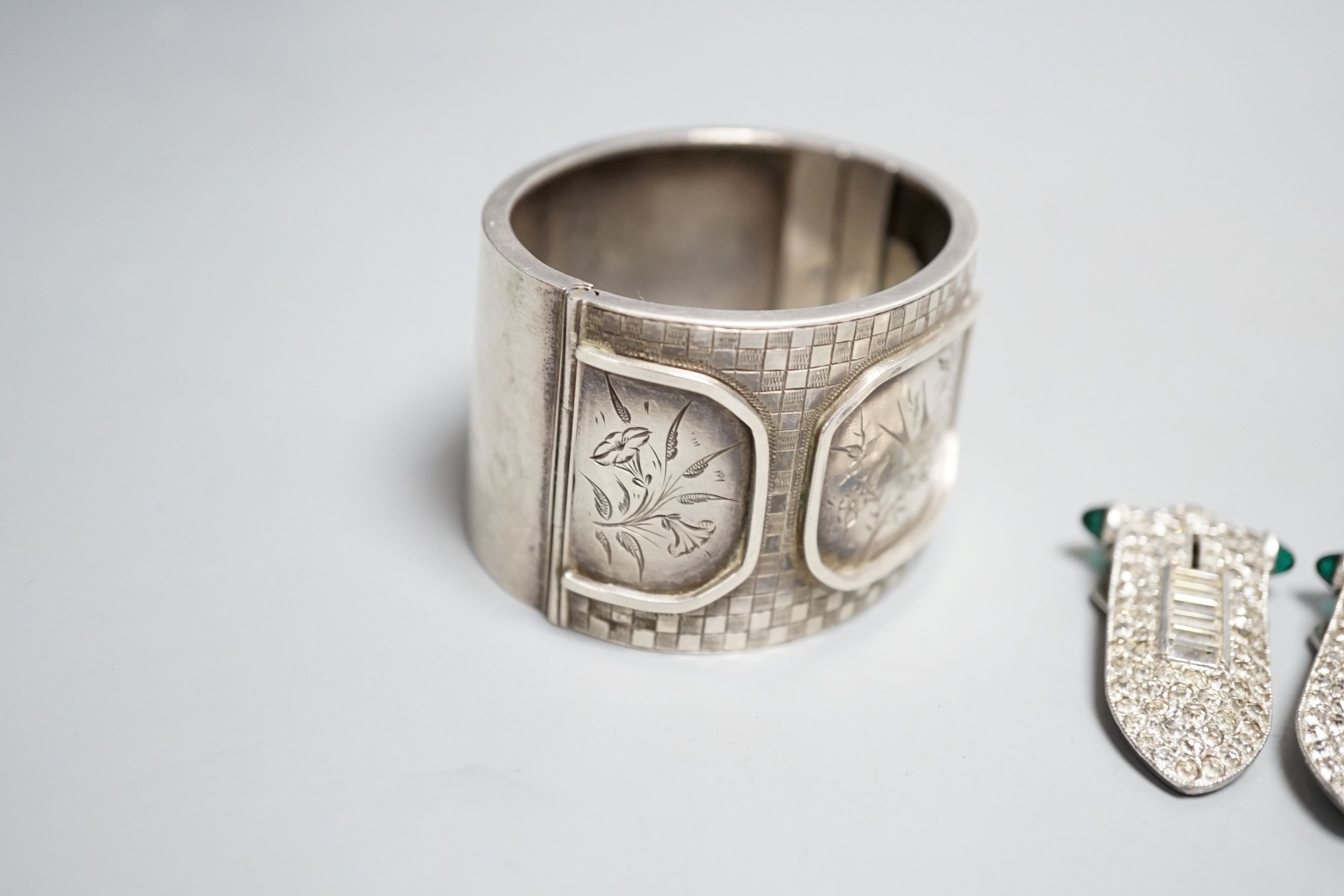 A pair of art deco paste clip earrings and a sterling bangle.